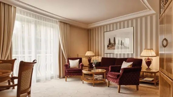 Interior view of a living room with couch, chairs and a coffee table.