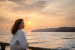 A woman is standing on the beach.