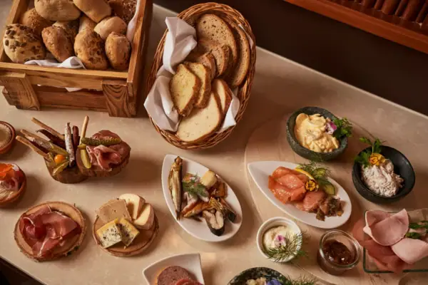 A table with a variety of food items and delicacies.