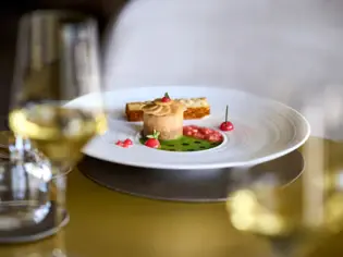 A plate of assorted foods on a table, accompanied by stemware.