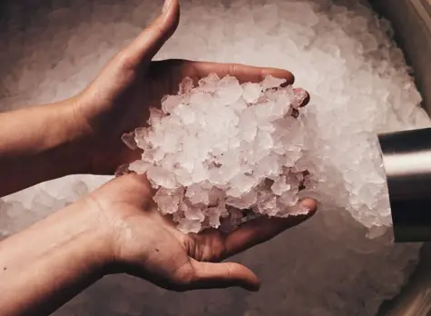 Person holding a pile of crushed ice.