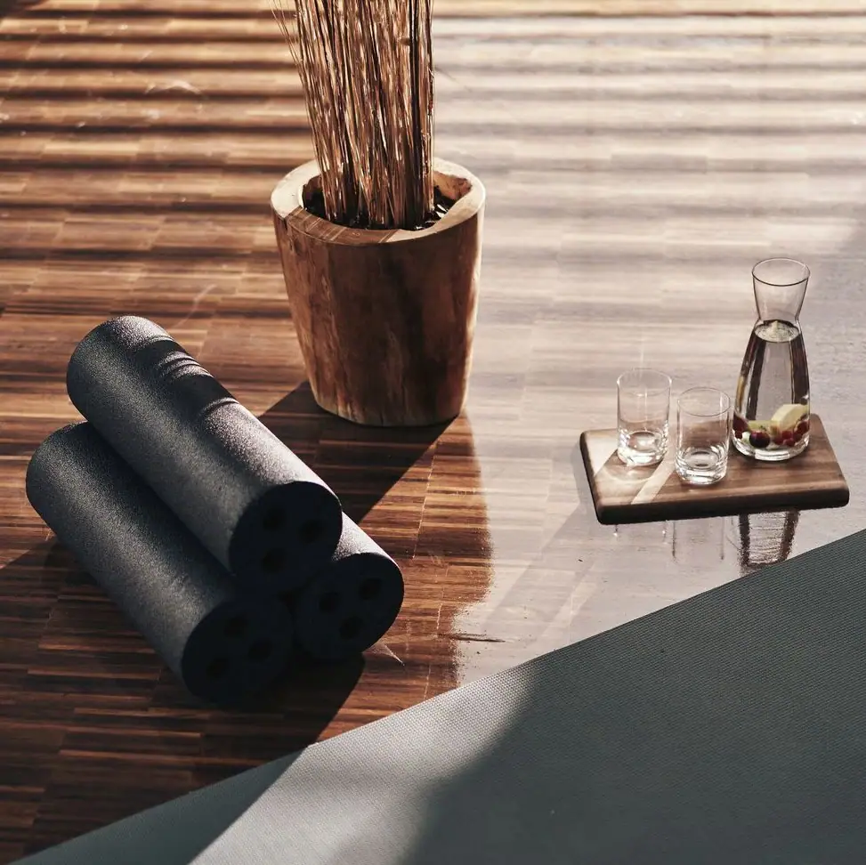 Yoga Yoga mats and glasses on a wooden floor.