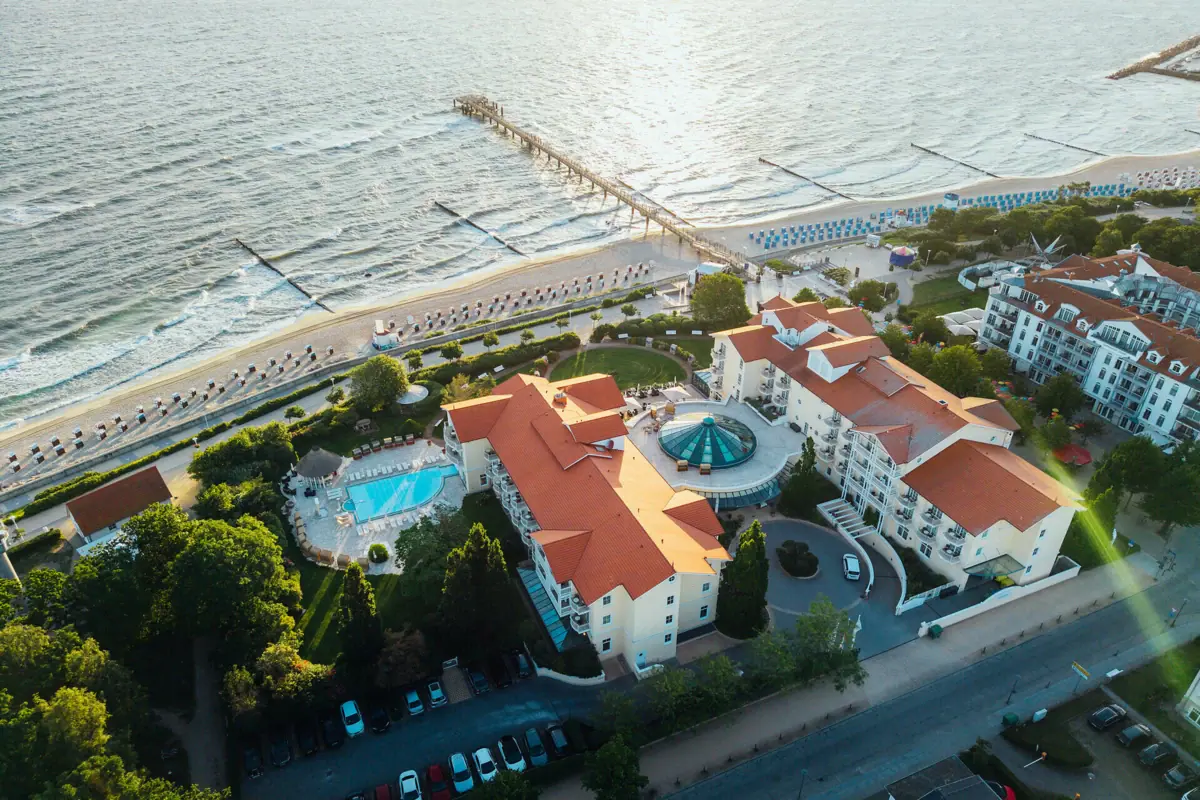 Aerial view of a holiday resort with a swimming pool and jetty