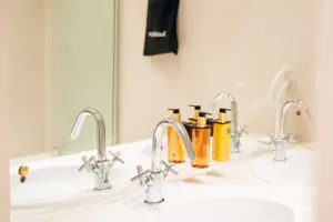 A bathroom with washbasin and taps.
