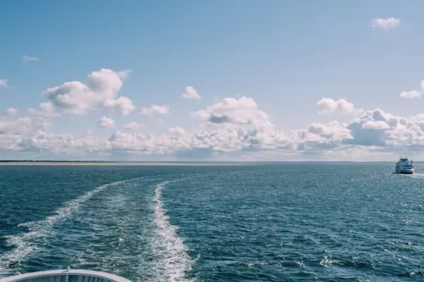 A boat on the water beneath a cloudy sky.