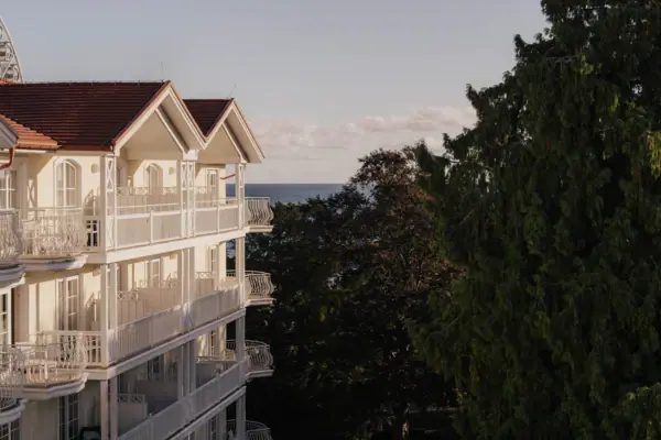 A building with trees and water in the background