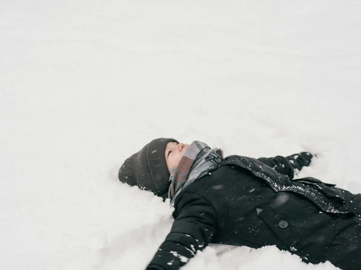 Eine Person liegt im Schnee.
