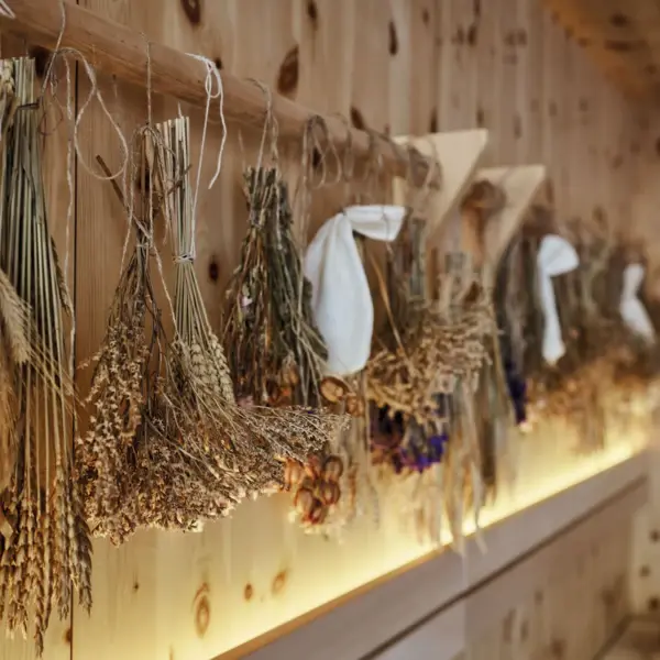 Dried flowers arranged on a sauna wall indoors.