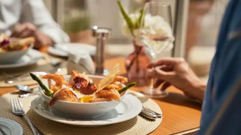 A bowl of shrimp on a plate.