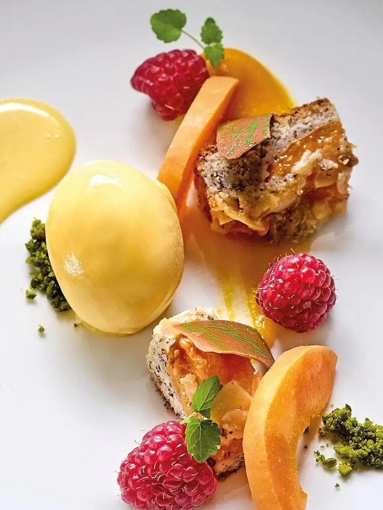 A plate with fruit and sauce.