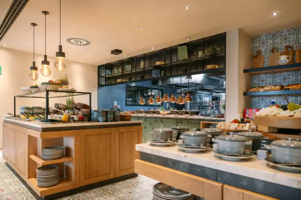 Küche mit vielen Geschirr- und Kochutensilien auf der Arbeitsplatte.