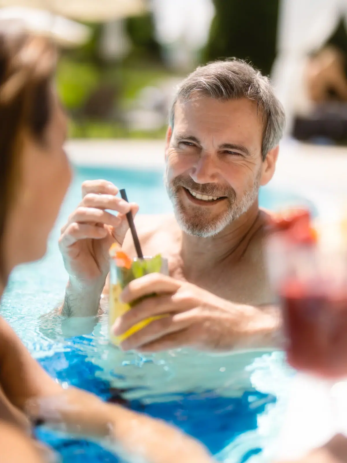 Pool party A man and a woman smiling in the pool.