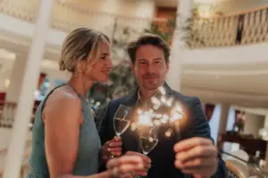 A man and a woman are holding wine glasses.
