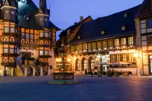 Exterior view of the A-ROSA Gothisches Haus at night, right next to the town hall in Wernigerode.