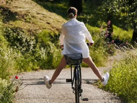 Woman riding a bicycle on a path.