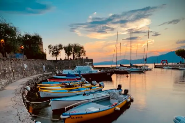 Torri del Benaco Boats on a body of water under a cloudy sky