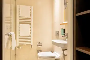 Bathroom with glass-door shower and washbasin.