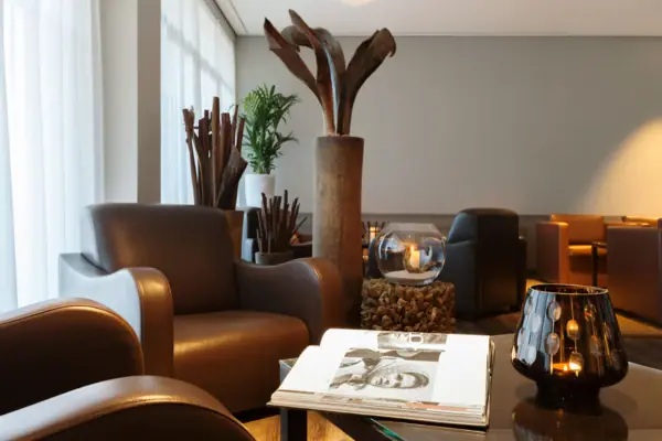 A room with brown chairs and a magazine on a table.