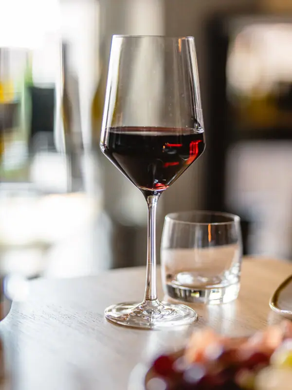 A glass of wine on a table.