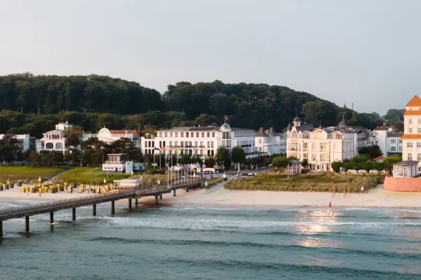 A body of water with buildings and trees in the background