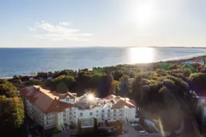 A building with trees and water in the background.