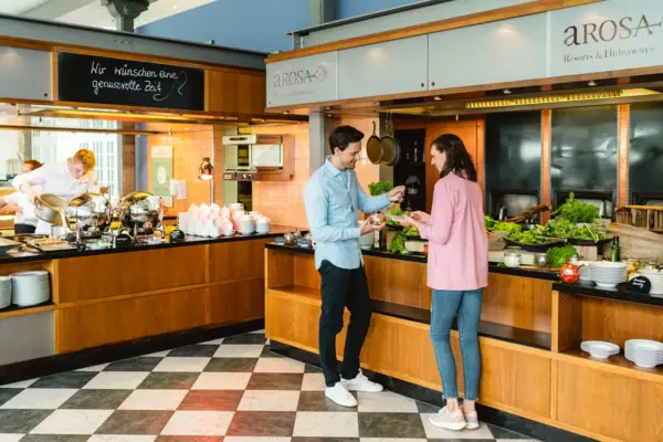 A man and a woman stand in front of a buffet
