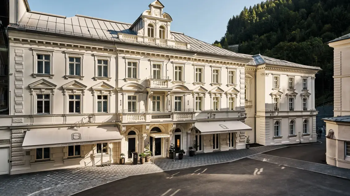 A bright old building with lots of windows and two awnings.