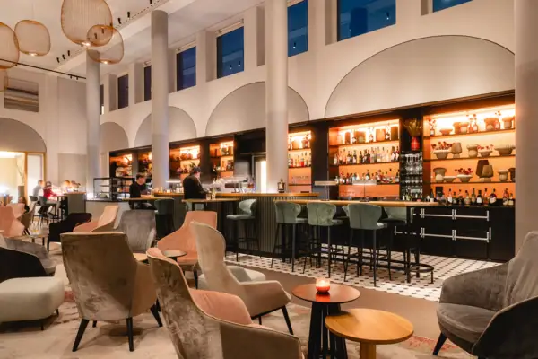 Eine Bar mit Stühlen und Tischen in einem großen Raum.