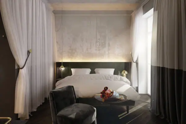 A bedroom featuring a neatly made bed and a small table.