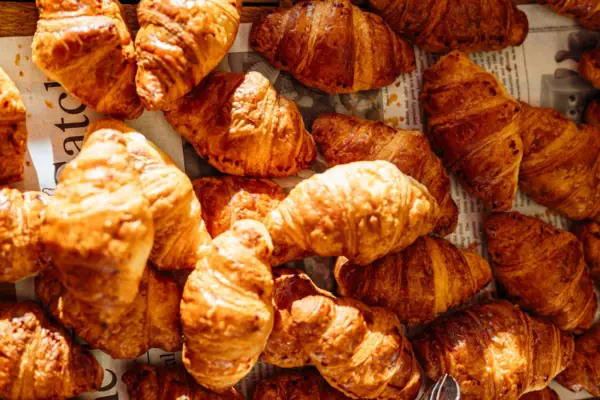 Breakfast in Travemünde A pile of croissants on a sheet of newspaper.