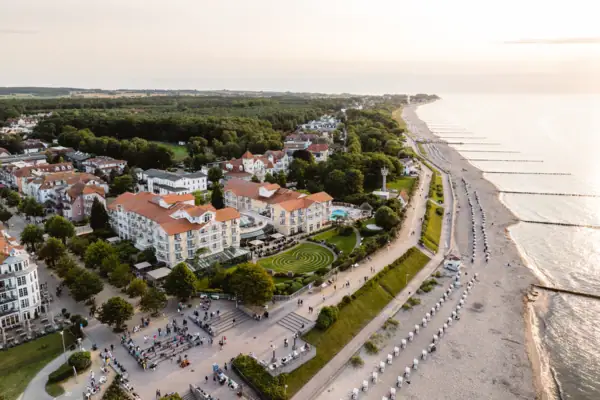Baltic Sea Hotel Kühlungsborn Beach with buildings and trees in the background.