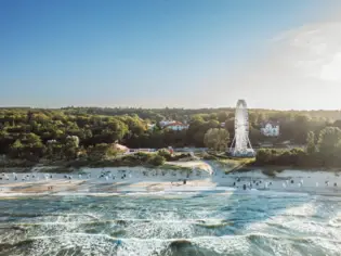 Beach with a Ferris wheel and trees.