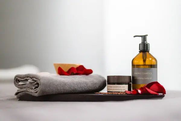 Towel and a glass bottle of liquid.