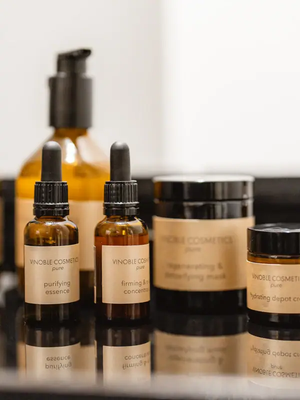 A group of glass cosmetic bottles indoors.