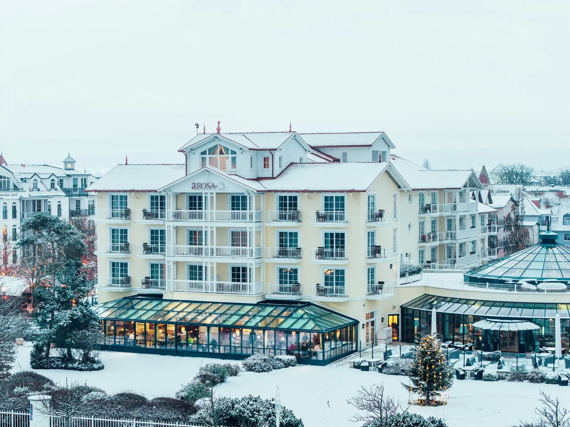 A building in the snow with trees in the background.
