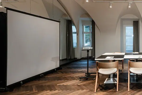 A room with a table and chairs, featuring indoor furniture and interior design elements.