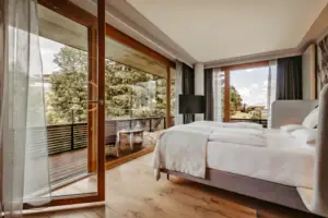 A bedroom with glass fronts and a bed.