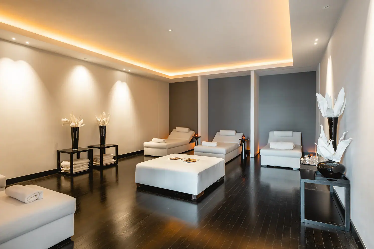 A room with white furniture and a fireplace.