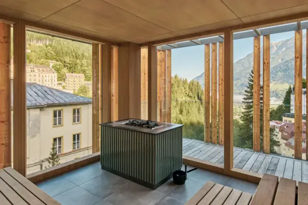 A room with a fireplace and wooden benches.