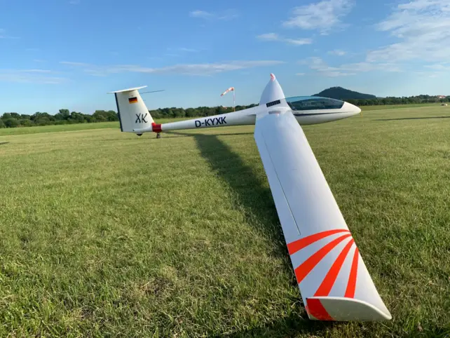 A glider on a grass field.