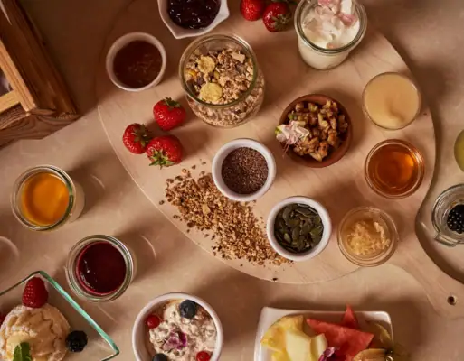A table with a variety of foods and tableware indoors.