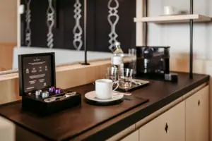 A coffee cup and a pair of glasses on a counter