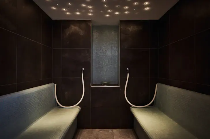 Two benches in a tiled room.