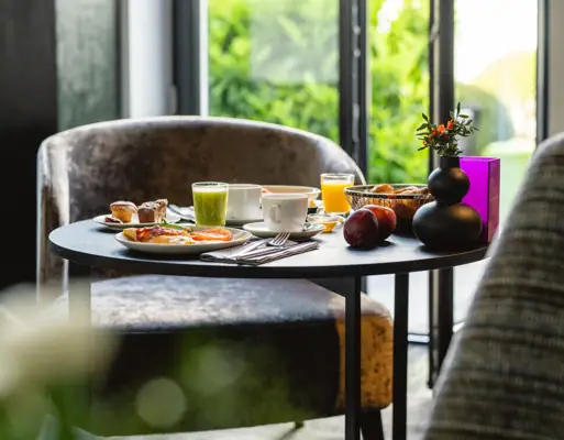 Breakfast A table set with various dishes and tableware.