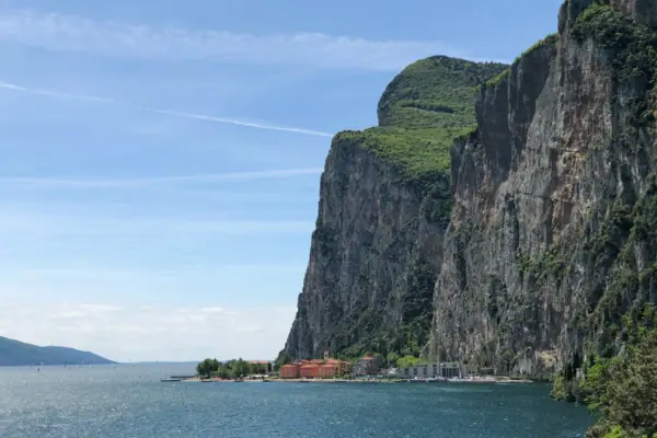 Tremosine A cliff with buildings standing on it, overlooking a body of water.