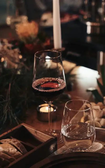 A glass of red wine on a table.