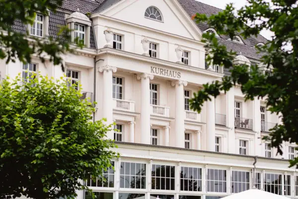 White building with trees in the background