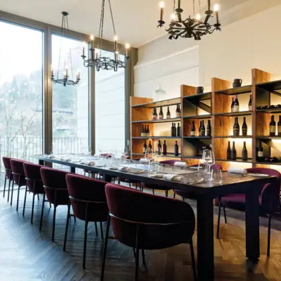 A room with a long table and chairs.
