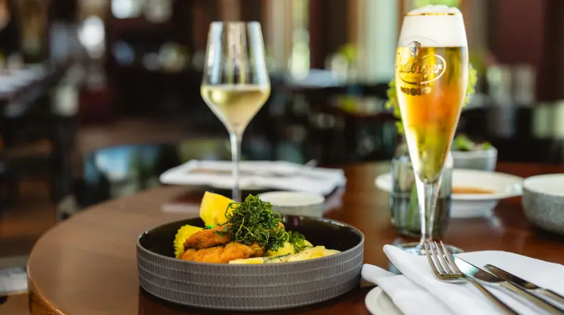 A plate of food and a glass of wine.