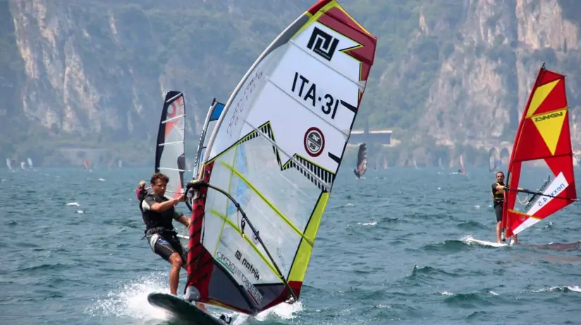 A man on a windsurfing board on Lake Garda.